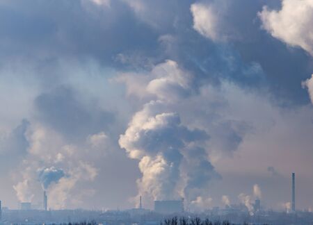 Smoke from the chimneys of a metallurgical plant at dawn.の写真素材