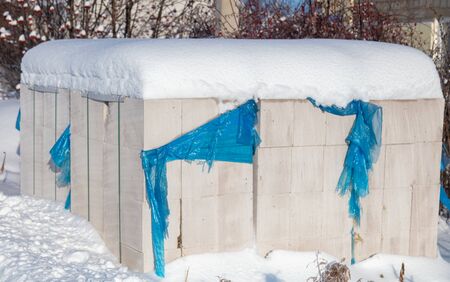 Bricks at a construction site in the snow in winter.の写真素材