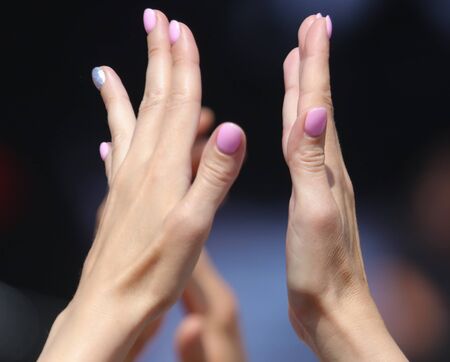 Hands clap at a rock concert.の写真素材