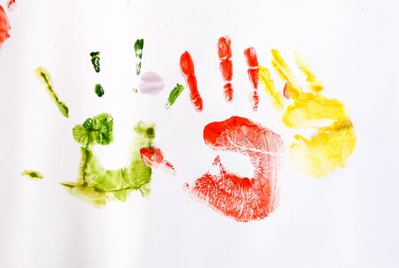 Imprints of children's hands on white paper.