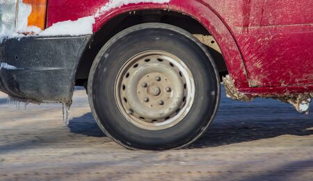 Car wheel in the snow in winter .