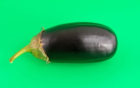 Eggplant isolated on a green background.の写真素材