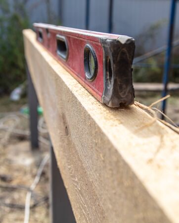 Worker measures the length of a construction site.