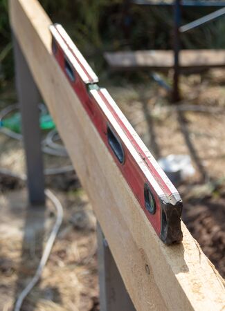 Worker measures the length of a construction site.