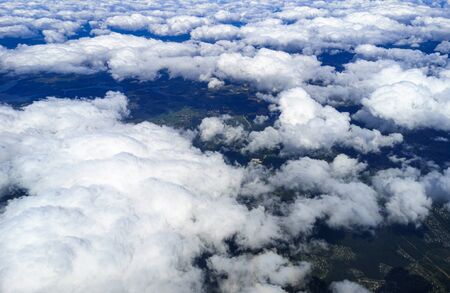 Clouds above the ground view from an airplane as a background.の写真素材
