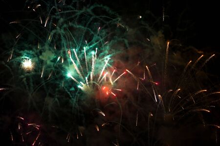 Colorful fireworks in the sky at night as background.
