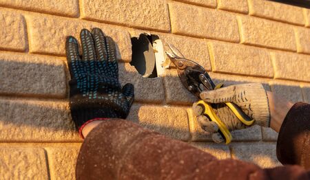 Installation of siding on the walls of the house. Construction workerの写真素材