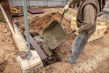 Concrete in a wheelbarrow at a construction site .の写真素材