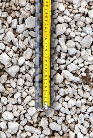 A meter on a stone rubble at a construction site.