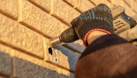 Installation of siding on the walls of the house. Construction workerの写真素材