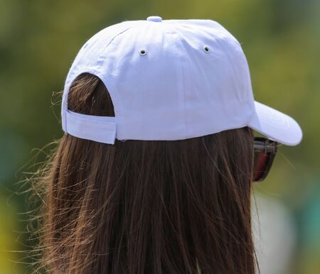 A white cap on the girlâ€™s head.