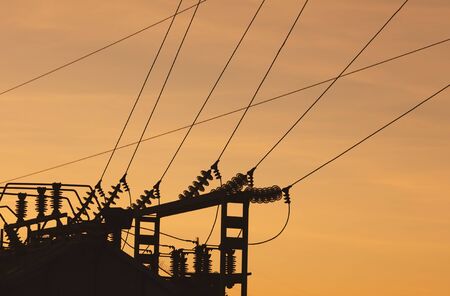Silhouette of electrical substation at sunset.の写真素材