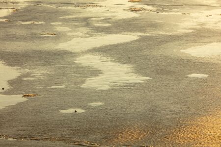 Ice on the lake at dawn of the sun. Abstract background