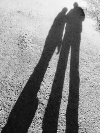 Shadow of two people on the road.の写真素材