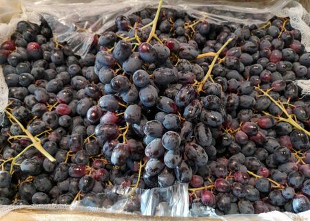 Ripe grapes in the store as a background.
