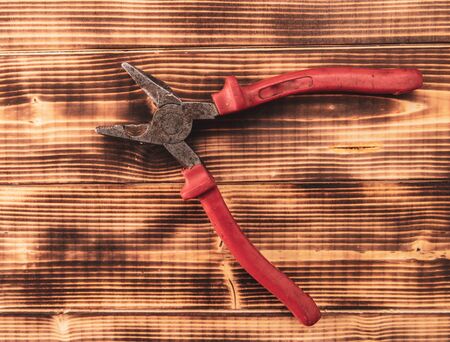 A screwdriver lies on a wooden background.の写真素材