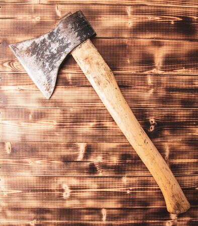 The ax lies on a wooden background.の写真素材