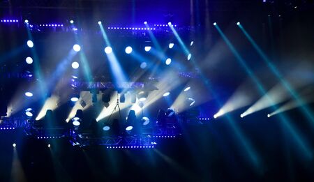 Blue light on a rock concert stage as background.