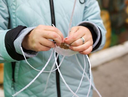 Girl weaves a basket with his hands.の写真素材