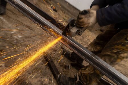 Sparks from sawing metal at a construction site.