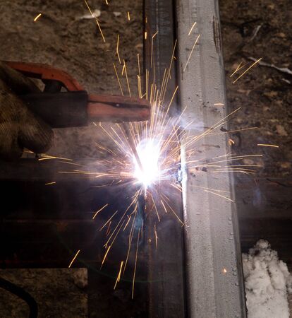sparks from metal welding at a construction site.