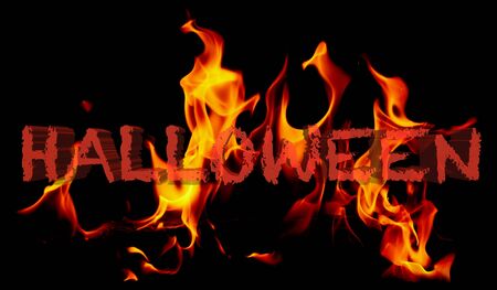 Halloween holiday on fire on a black background .の写真素材