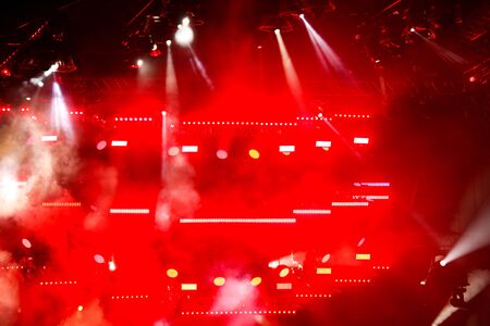 Red light on a rock concert stage as background.