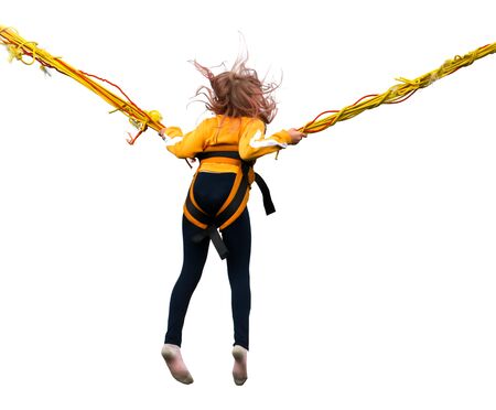 Girl jumping on a bungee isolated on a white background.