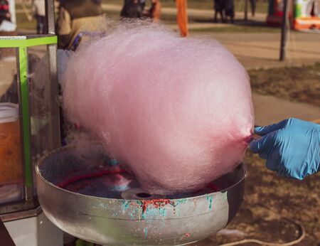 Cooking red cotton candy in the park.の写真素材
