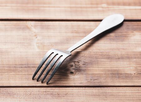 Food fork on a wooden background.の写真素材