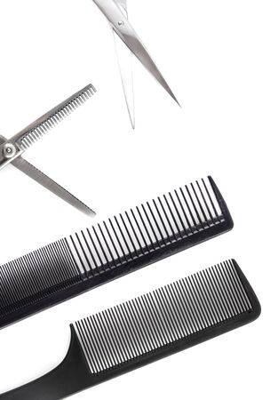 Scissors and combs for cutting hair on a white background.の写真素材