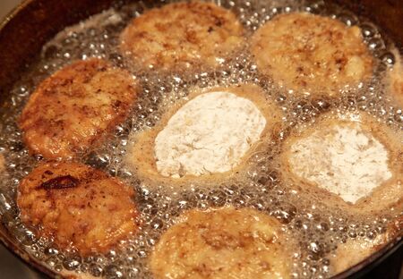 Meat patties fried in a pan in the kitchen.の写真素材