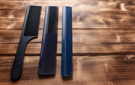 Hairbrushes for haircuts on a wooden background.の写真素材