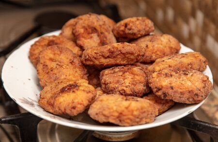 Meat patties fried in a pan in the kitchen.の写真素材