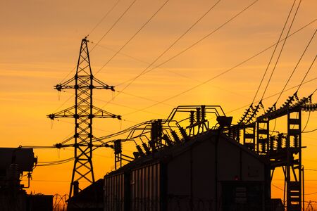 Silhouette of electrical substation at sunset.