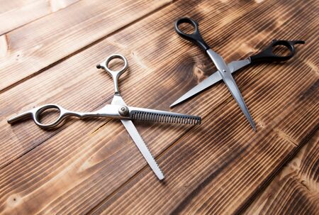 Scissors for haircuts on a wooden background.の写真素材
