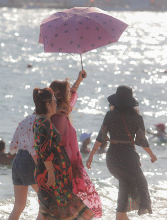 Sanya, Hainan Island, China - January 8, 2020: People bathe on the beach in Dadonghai Bay.のeditorial素材