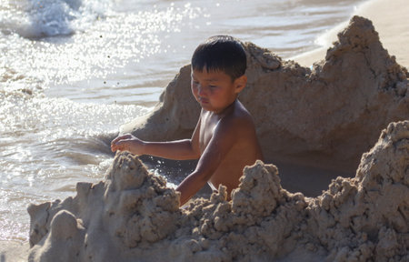 Sanya, Hainan Island, China - January 8, 2020: Boy on the beach in Dadonghai Bay.のeditorial素材