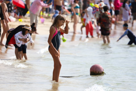 Sanya, Hainan Island, China - January 8, 2020: People bathe on the beach in Dadonghai Bay.のeditorial素材