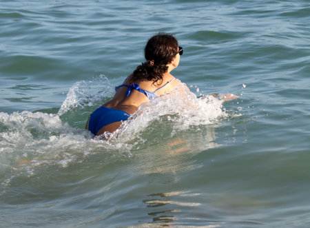 Sanya, Hainan Island, China - January 8, 2020: Girl on the beach in Dadonghai Bay.のeditorial素材
