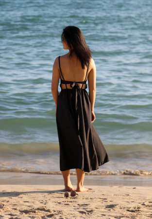 Sanya, Hainan Island, China - January 8, 2020: Girl on the beach in Dadonghai Bay.のeditorial素材