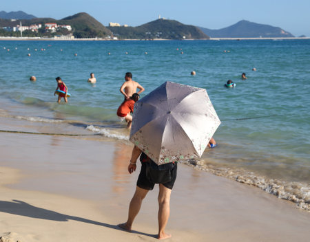 Sanya, Hainan Island, China - January 8, 2020: People bathe on the beach in Dadonghai Bay.のeditorial素材