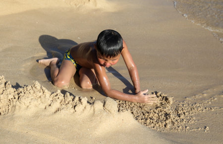 Sanya, Hainan Island, China - January 8, 2020: Boy on the beach in Dadonghai Bay.のeditorial素材