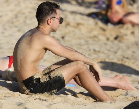 Sanya, Hainan Island, China - January 8, 2020: A man on the beach in Dadonghai Bay.のeditorial素材