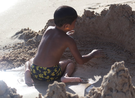 Sanya, Hainan Island, China - January 8, 2020: Boy on the beach in Dadonghai Bay.のeditorial素材