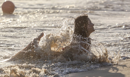 Sanya, Hainan Island, China - January 8, 2020: Girl at sunset on the beach in Dadonghai Bay.のeditorial素材
