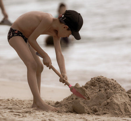 Sanya, Hainan Island, China - January 8, 2020: Boy on the beach in Dadonghai Bay.のeditorial素材