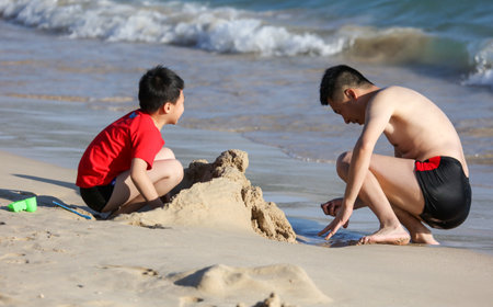 Sanya, Hainan Island, China - January 8, 2020: People bathe on the beach in Dadonghai Bay.のeditorial素材