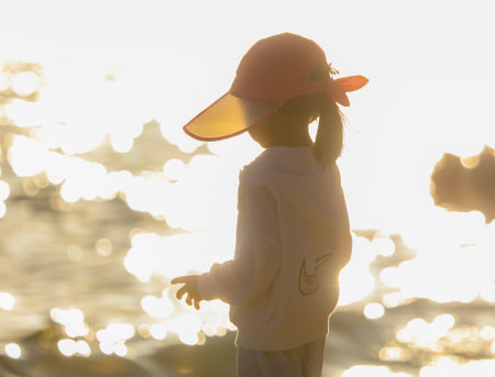 Sanya, Hainan Island, China - January 8, 2020: Girl in a hat on the beach in Dadonghai Bayのeditorial素材