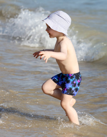 Sanya, Hainan Island, China - January 8, 2020: Boy on the beach in Dadonghai Bay.のeditorial素材